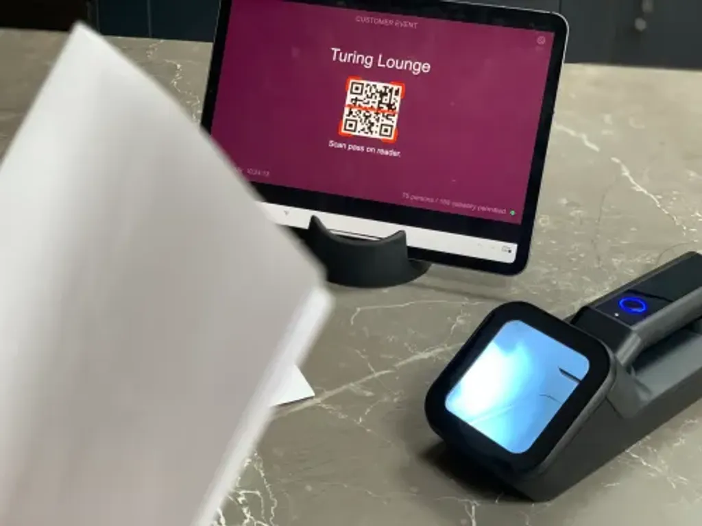 The Power App Entry Point screen on an iPad, showing the event branding and a prompt to scan a pass barcode.