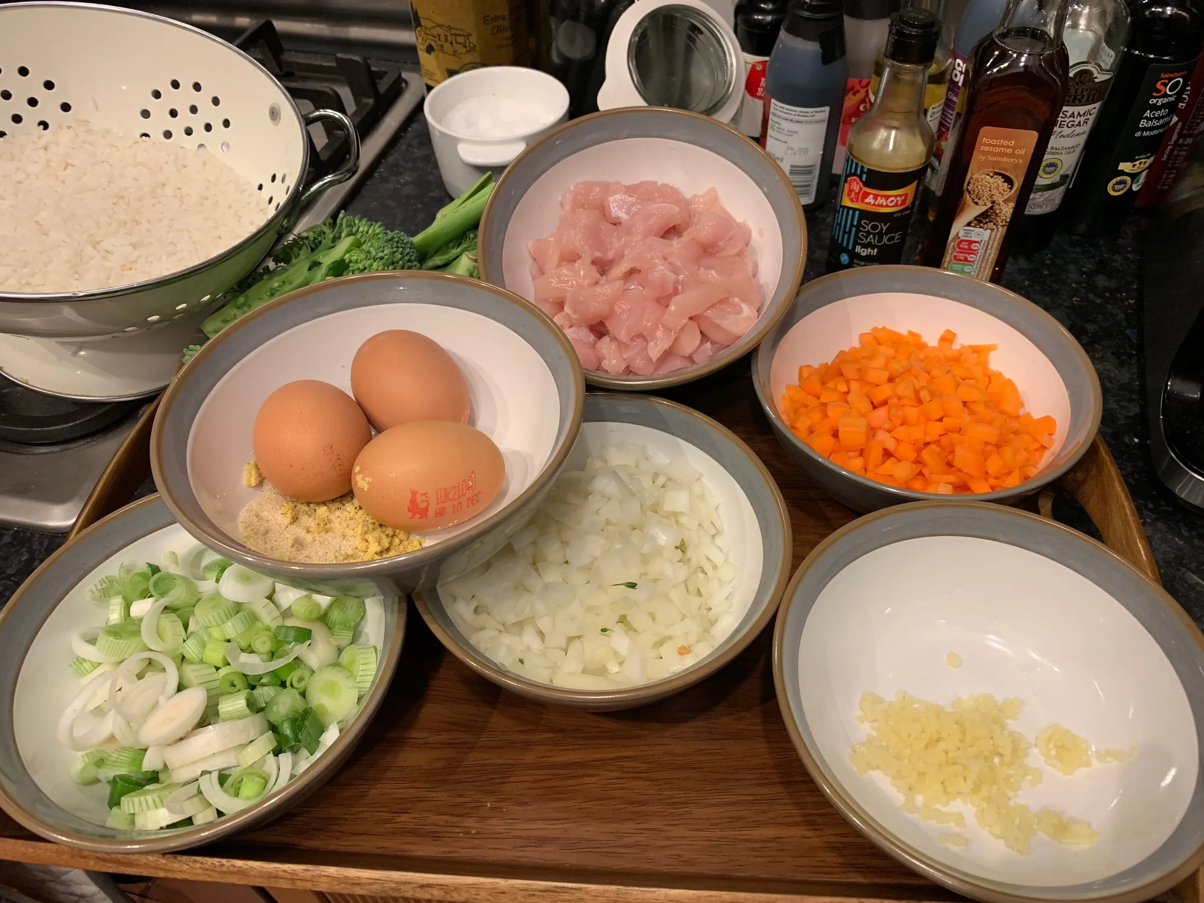 Fried rice ingredients prepared in bowls on a tray ready for cooking