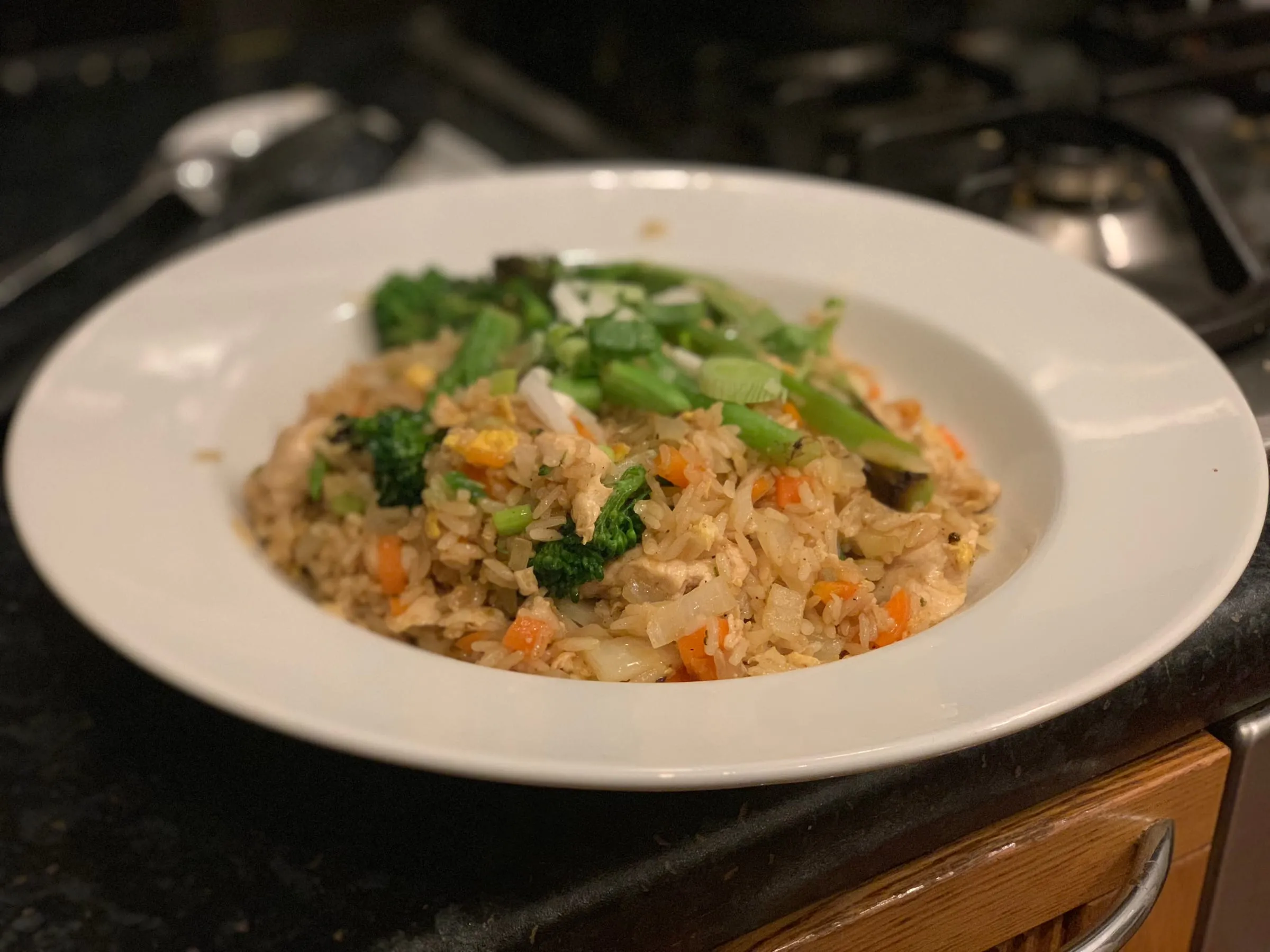 A bowl of chicken and vegetable egg fried rice