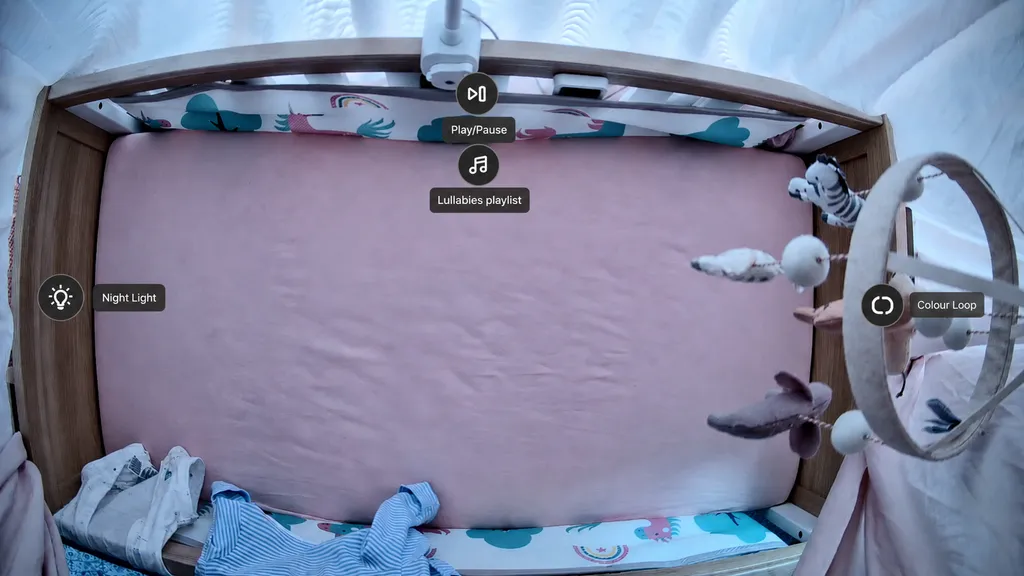 A mockup of the UniFi Protect cot camera live view showing shortcut bubbles with distinct icons and labels for each action.