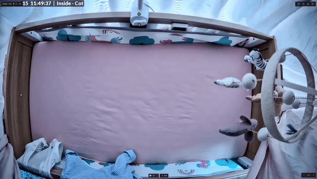 The UniFi G6 Instant live view showing the cot with four shortcut bubbles visible along the bottom of the feed.